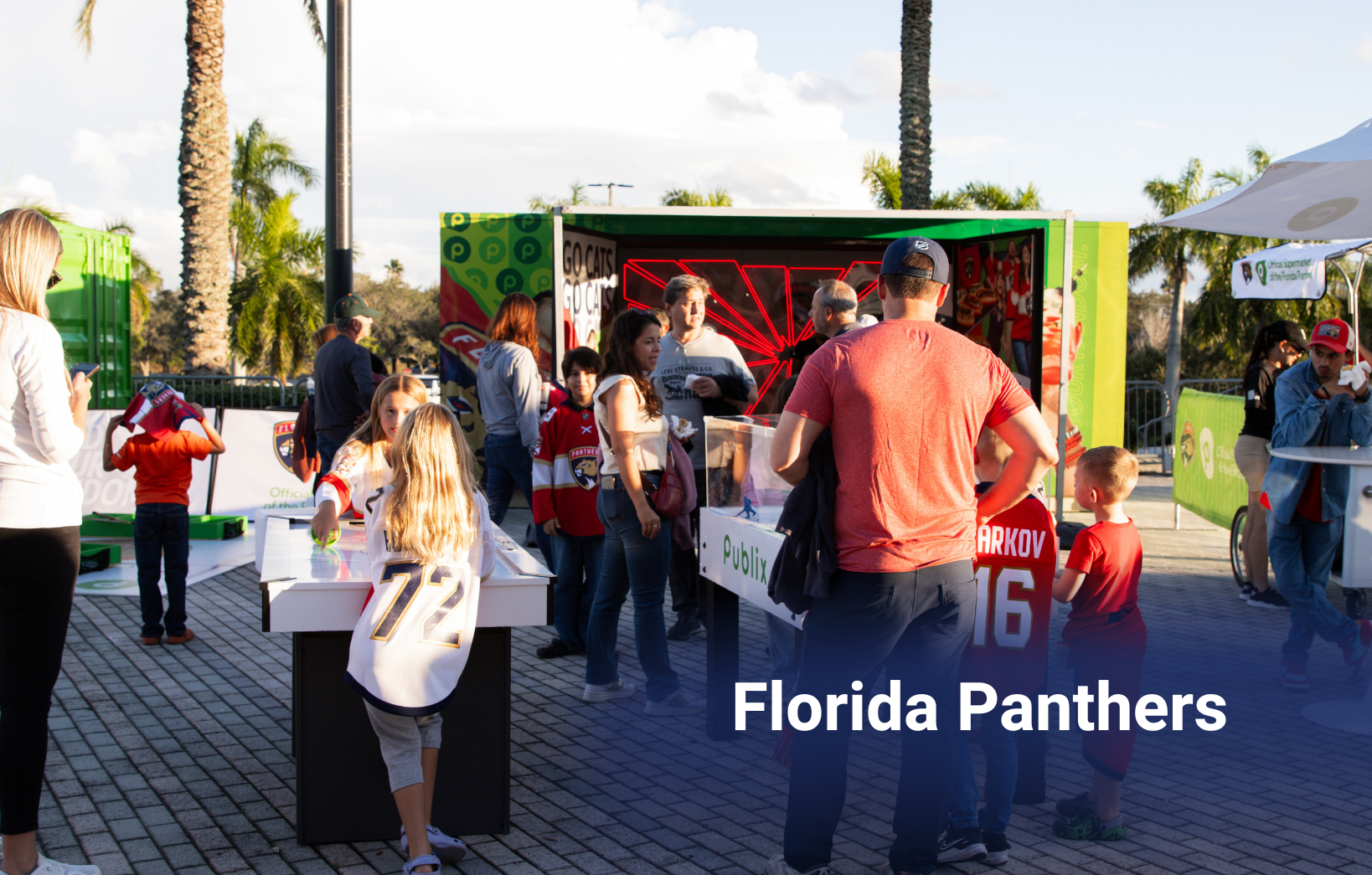 Families and fans interacting at an outdoor Florida Panthers event featuring games and team-branded displays.